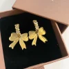 Gold Bow Huggie Hoops